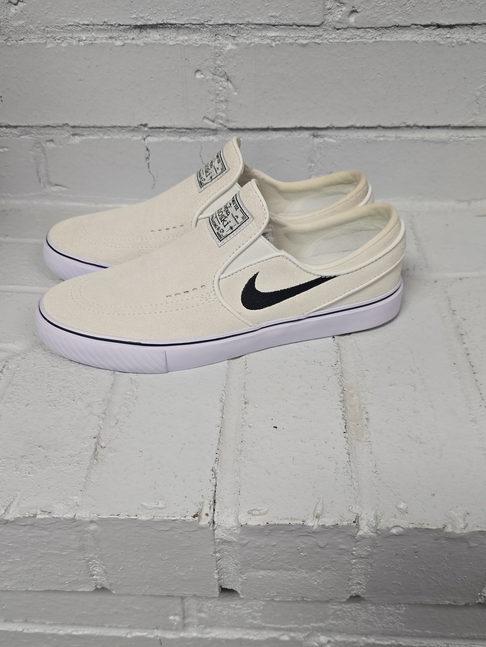 Nike Slip-On Sneakers in Off-White with Black Swoosh
